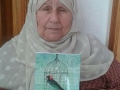 Mother of Hassan Salama receives a copy of the book. Salama is still in Israeli jail and is sentenced to 48 life sentences #TPD.jpg