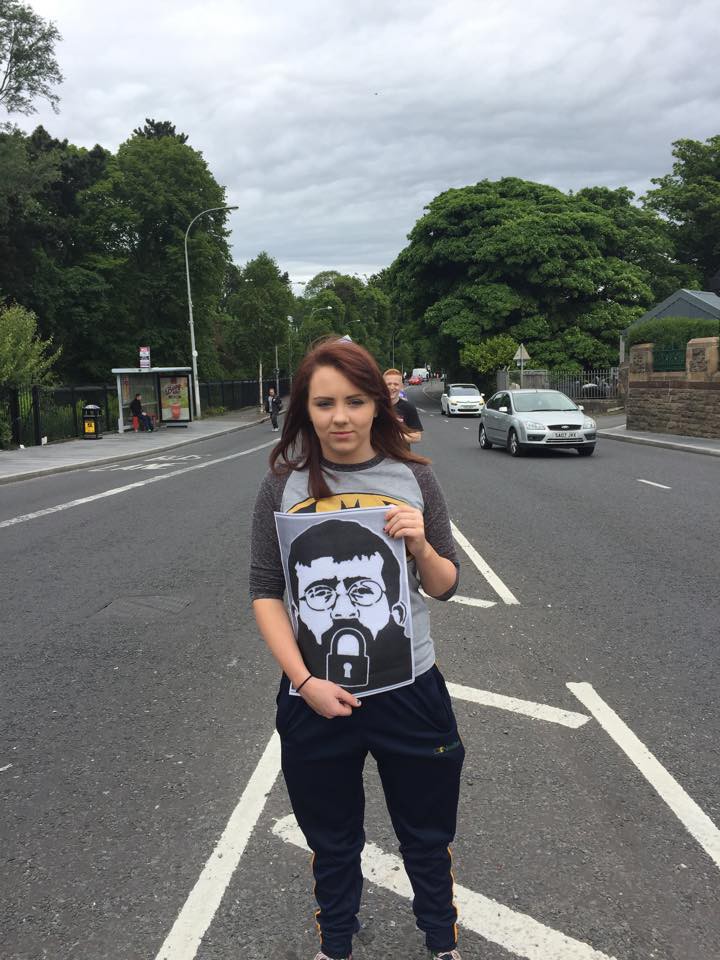 A Belfast youth activist holds a sign depicting Khader Adnan as part of a 19 June protest in solidarity with the hunger striker. (via Facebook)