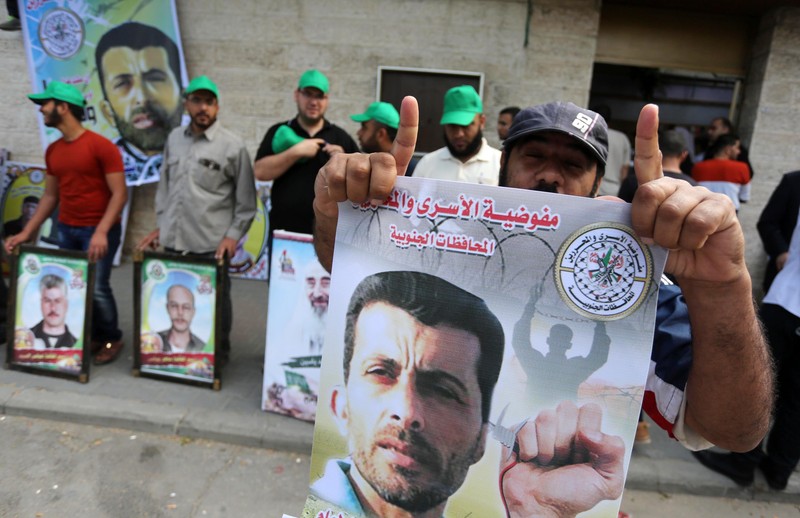 Palestinians take part in a protest demanding release the prisoners in Israeli jails, in front of Red cross office, in Gaza city, on May 2, 2016. Photo by Mohammed Asad