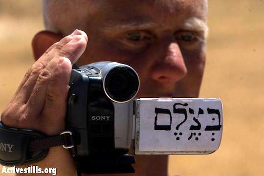 A Palestinian B’Tselem volunteer documents a protest in the South Hebron Hills, June 14, 2008. (Oren Ziv/Activestills)
