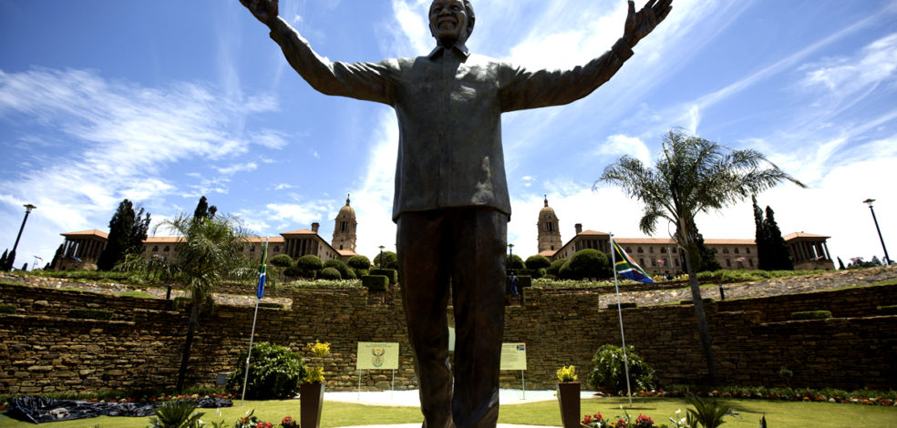 PRETORIA, SOUTH AFRICA - DECEMBER 16:  A statue of former South African president Nelson Mandela is unveiled at the Union Buildings on December 16, 2013 in Pretoria, South Africa.  South African president Jacob Zuma unveiled a 9 meter bronze statue of former South African president Nelson Mandela as part of the Day of Reconciliation celebrations.  (Photo by Oli Scarff/Getty Images)