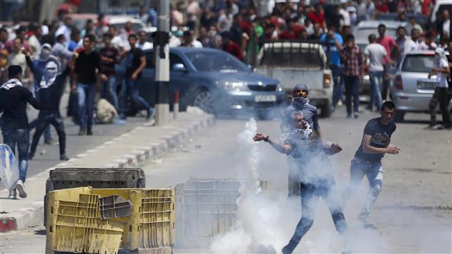 Palestinians throw stones towards Israeli troops during clashes following a protest in support of the prisoners on hunger strike in Israeli jails, in the West Bank town of Beita, May 5, 2017. (Photo by AP)