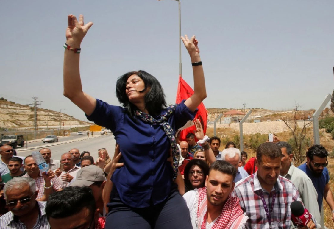 Palestinian lawmaker Khalida Jarrar gestures as she is carried by Palestinian activists after her release from an Israeli jail at Israeli Jbara checkpoint near the West Bank city of Tulkarm in 2016. (Abed Omar Qusini/Reuters)