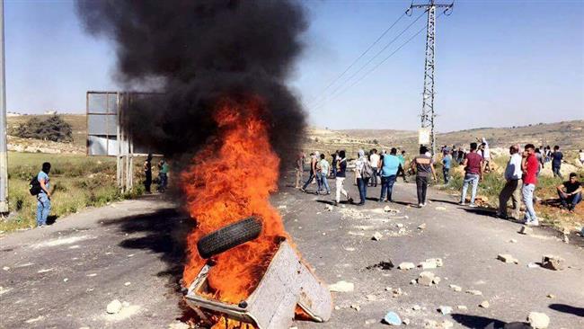 This photo shows a fire during clashes between Israeli forces and Palestinians protesting in solidarity with hunger-striking prisoners near the Israeli Beit El settlement north of Ramallah, May 11, 2017.