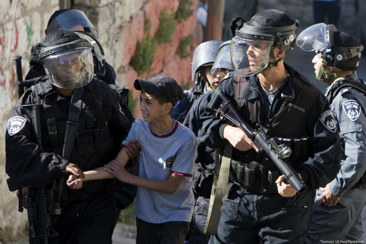Israeli forces can be seen arresting a Palestinian child [Taimoor Ul Haq/Facebook]
