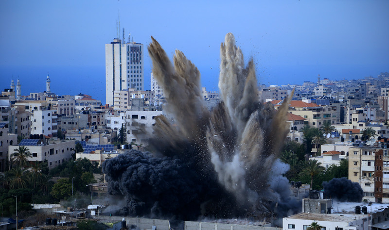 Smoke is seen rising following an Israeli airstrike on a building in Gaza City on 5 May. Israel’s attack on Gaza entered its third day Sunday, as the death toll continued to climb. Ibrahim Khalaf APA images