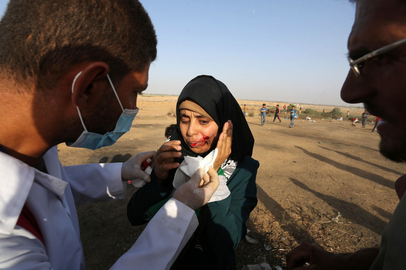 A protester is treated by paramedics during Great March of Return protests in Khan Younis, southern Gaza Strip, on 12 July. Ashraf Amra APA images)