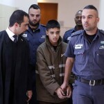 Ahmed Mansra is escorted by Israeli security during a hearing at a Jerusalem court on October 30, 2015. Photo by AHMAD GHARABLI/AFP via Getty Images.