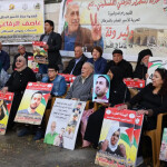 This image from November 21 shows relatives and supporters of Palestinians held in Israeli prisons staging a sit-in outside the Red Cross in Ramallah in the West Bank [Jaafar Ashtiyeh/AFP]