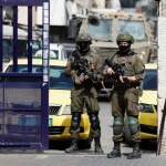Israeli soldiers stand guard during a raid in Ramallah, in the Israeli-occupied West Bank, October 13, 2026 [Mohamad Torokman/Reuters]